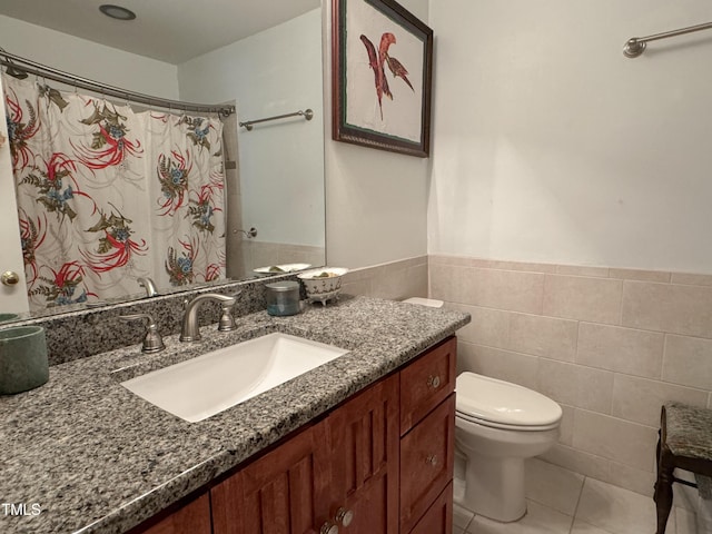 700 Sawmill Rd, Raleigh, NC 27615 - bathroom featuring a wainscoted wall, tile patterned floors, toilet, vanity, and tile walls