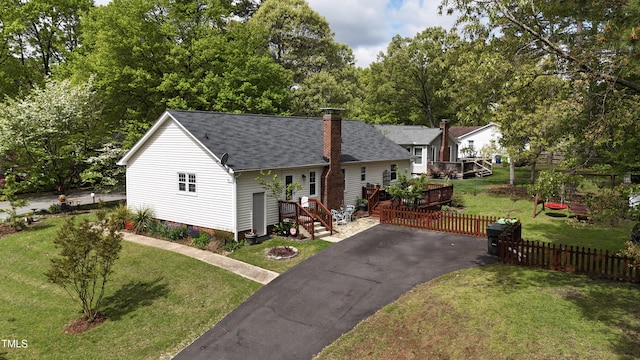 700 Sawmill Rd, Raleigh, NC 27615 - view of front facade featuring fence, a shingled roof, a front lawn, and a chimney