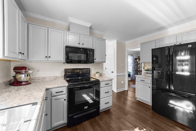 kitchen with crown molding, dark wood-style floors, a sink, and black appliances