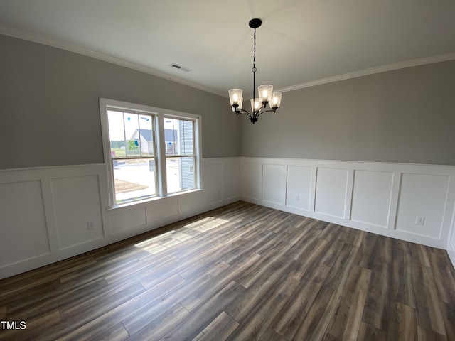 interior space featuring a decorative wall, an inviting chandelier, ornamental molding, dark wood-type flooring, and visible vents