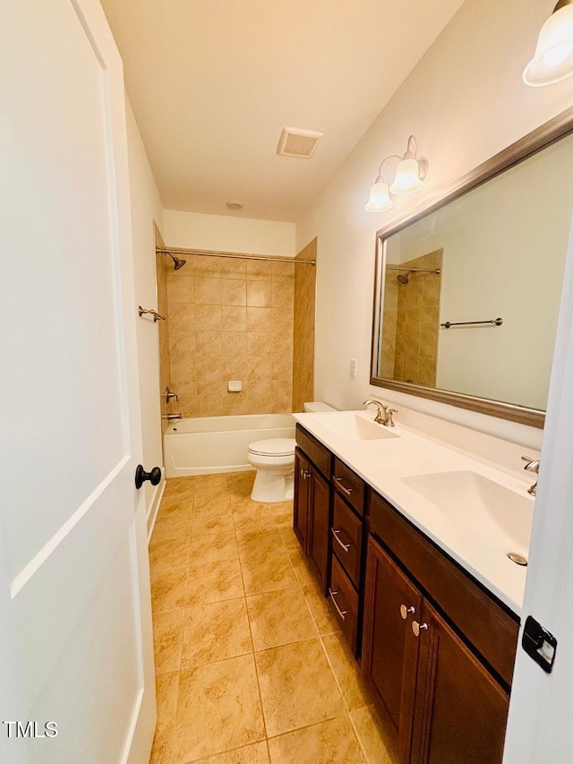 full bathroom featuring double vanity, toilet, tub / shower combination, and a sink