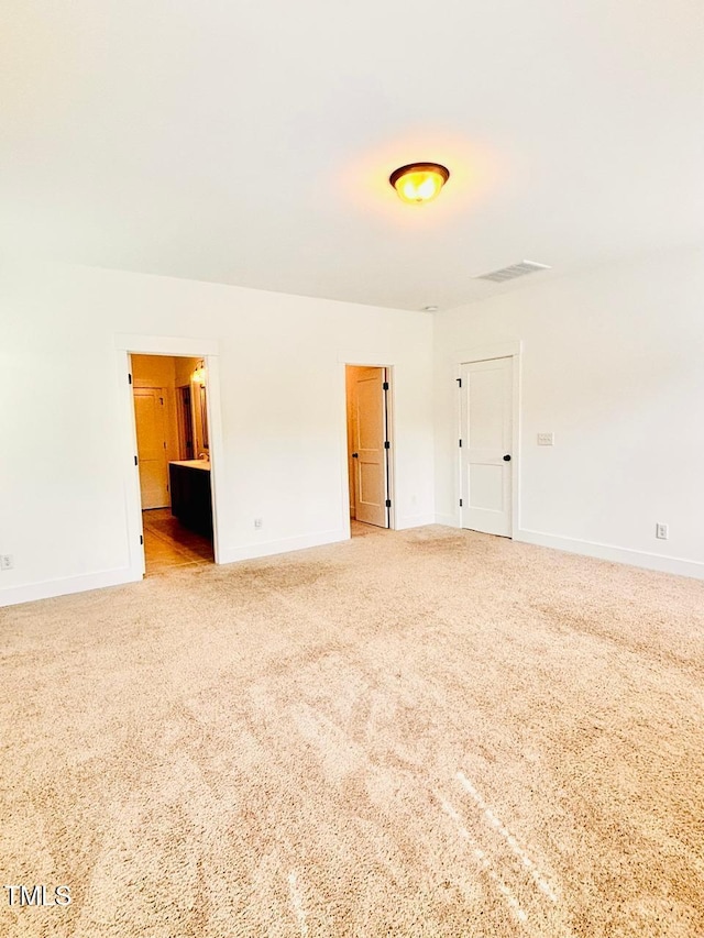 spare room featuring baseboards and carpet flooring