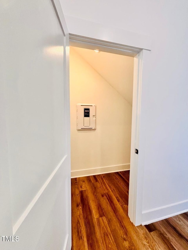 laundry room with wood finished floors and baseboards