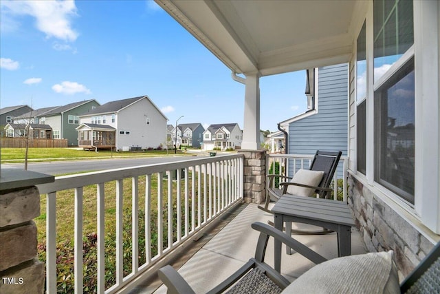balcony with a residential view and covered porch