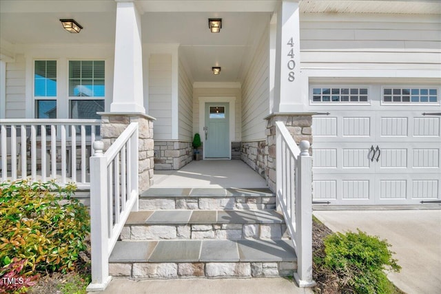 property entrance with a garage, stone siding, and covered porch