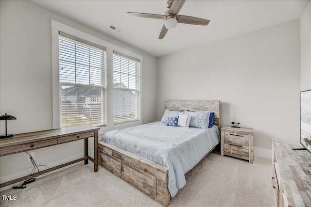 bedroom featuring light carpet, baseboards, visible vents, and a ceiling fan