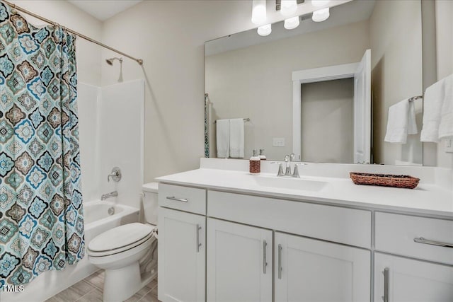 full bathroom featuring shower / bath combo with shower curtain, vanity, and toilet