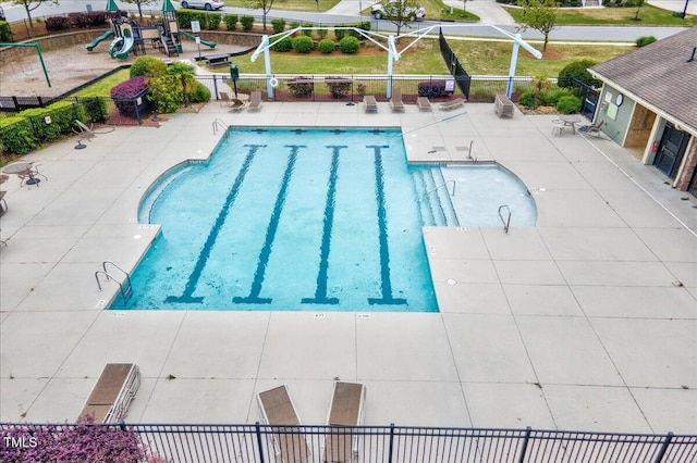pool with a patio and fence
