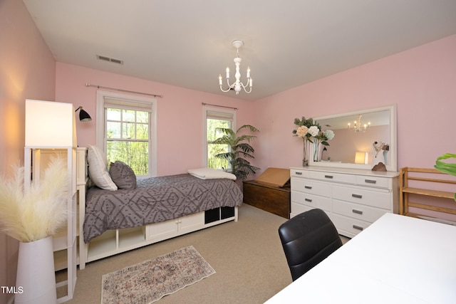 221 Ironwoods Dr, Chapel Hill, NC 27516 - carpeted bedroom featuring visible vents and a notable chandelier