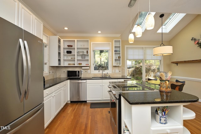 221 Ironwoods Dr, Chapel Hill, NC 27516 - kitchen featuring stainless steel appliances, open shelves, a sink, a skylight, and white cabinetry