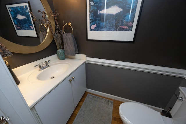 221 Ironwoods Dr, Chapel Hill, NC 27516 - half bathroom featuring baseboards, wood finished floors, vanity, and toilet