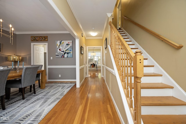 221 Ironwoods Dr, Chapel Hill, NC 27516 - hallway featuring wood finished floors, crown molding, baseboards, and stairway