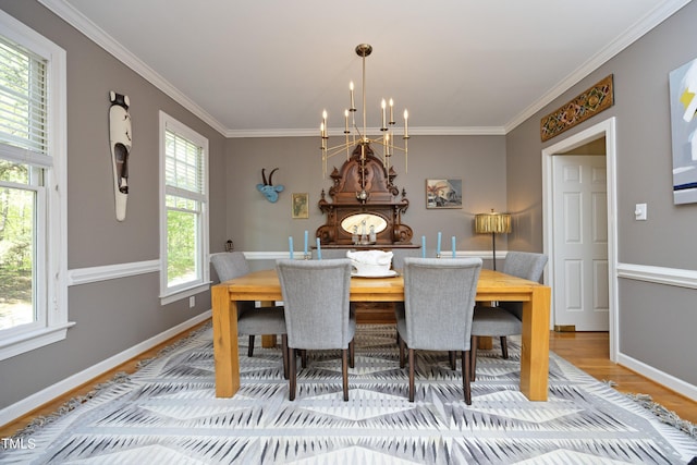 221 Ironwoods Dr, Chapel Hill, NC 27516 - dining area with baseboards, crown molding, a chandelier, and light wood finished floors