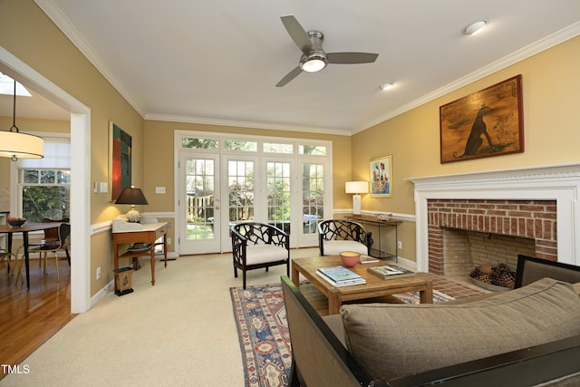 221 Ironwoods Dr, Chapel Hill, NC 27516 - carpeted living area with plenty of natural light, a ceiling fan, a fireplace, and ornamental molding