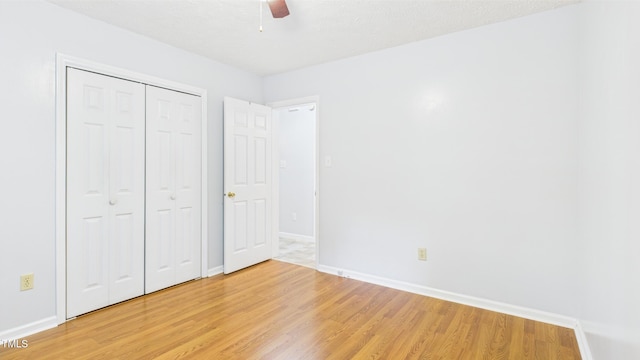 196 Tara Ln, Timberlake, NC 27583 - unfurnished bedroom featuring baseboards, light wood-style flooring, ceiling fan, and a closet