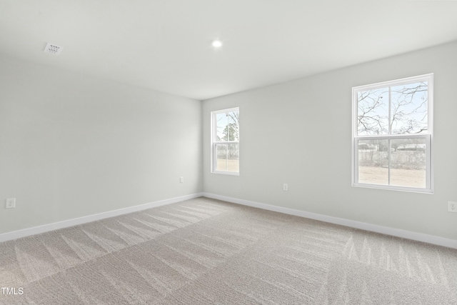 spare room with recessed lighting, visible vents, baseboards, and light colored carpet