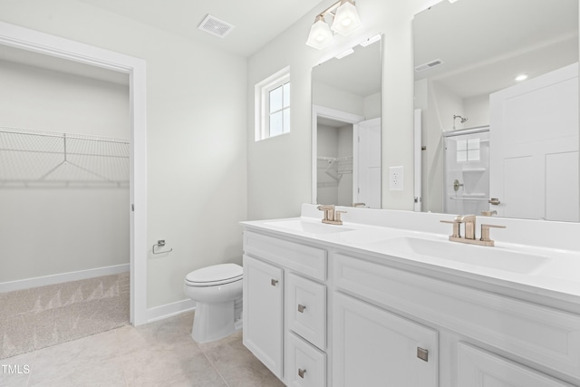 bathroom with toilet, a sink, and visible vents