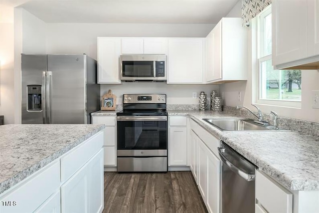 363 Tormore Dr, Sanford, NC 27330 - kitchen with dark wood-style floors, light countertops, a sink, and appliances with stainless steel finishes