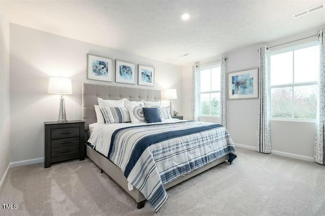 363 Tormore Dr, Sanford, NC 27330 - bedroom with light colored carpet, baseboards, and visible vents