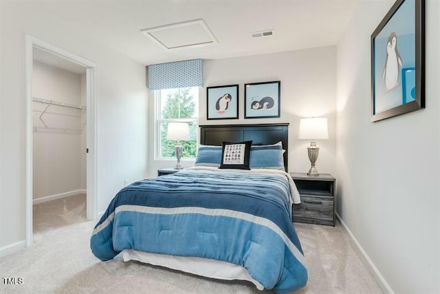 363 Tormore Dr, Sanford, NC 27330 - bedroom featuring baseboards, attic access, carpet floors, a walk in closet, and visible vents