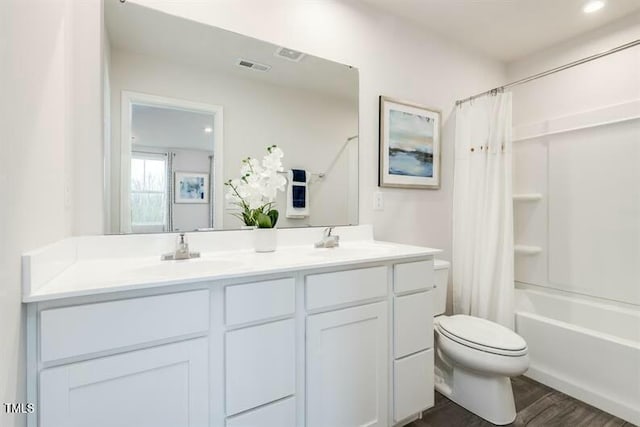 363 Tormore Dr, Sanford, NC 27330 - bathroom with toilet, wood finished floors, double vanity, and a sink
