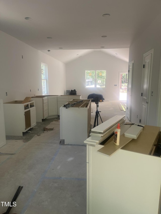 5875 Green Pine Rd, Cedar Grove, NC 27231 - kitchen featuring vaulted ceiling, plenty of natural light, open floor plan, and white cabinetry