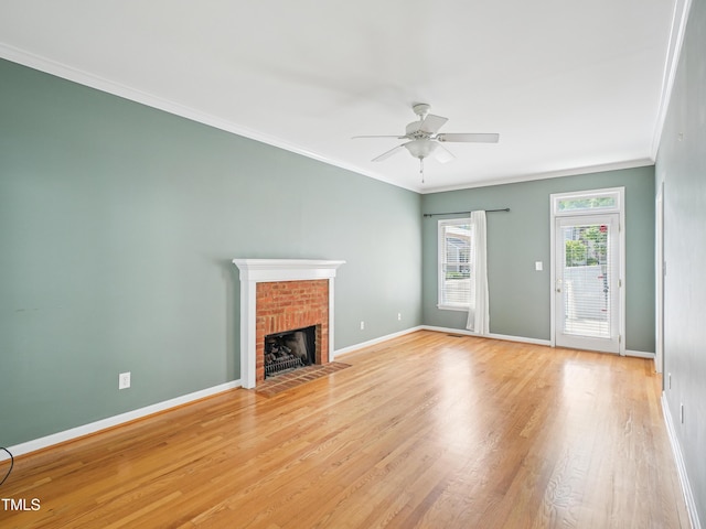 3303 Glen Currin Dr, Raleigh, NC 27612 - unfurnished living room featuring baseboards, a ceiling fan, a fireplace, ornamental molding, and light wood-style floors
