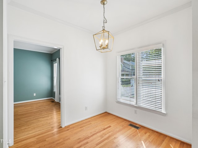 3303 Glen Currin Dr, Raleigh, NC 27612 - empty room featuring crown molding, a chandelier, light wood-style flooring, and baseboards