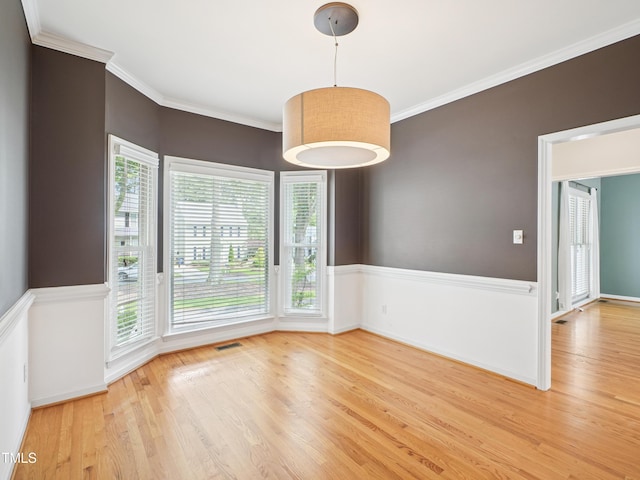 3303 Glen Currin Dr, Raleigh, NC 27612 - spare room featuring light wood-type flooring, plenty of natural light, ornamental molding, and baseboards