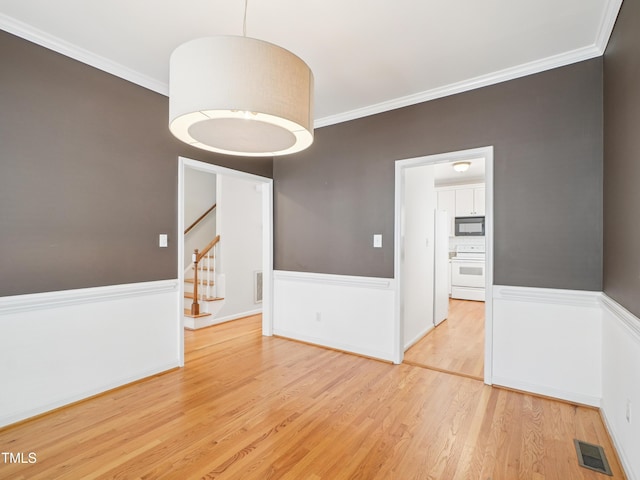 3303 Glen Currin Dr, Raleigh, NC 27612 - spare room with wood finished floors, stairway, and ornamental molding
