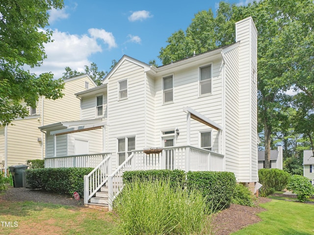 3303 Glen Currin Dr, Raleigh, NC 27612 - back of property featuring a chimney and a deck