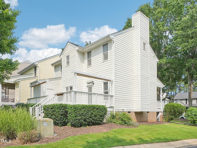 3303 Glen Currin Dr, Raleigh, NC 27612 - view of side of property with crawl space, a yard, and a chimney