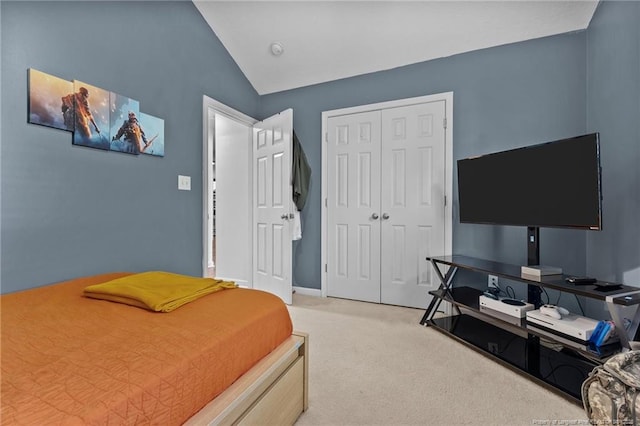 bedroom with light carpet, a closet, baseboards, and lofted ceiling