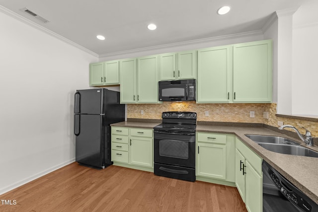 1120 Renewal Pl Unit 111, Raleigh, NC 27603 - kitchen featuring black appliances, green cabinets, a sink, ornamental molding, and light wood-type flooring