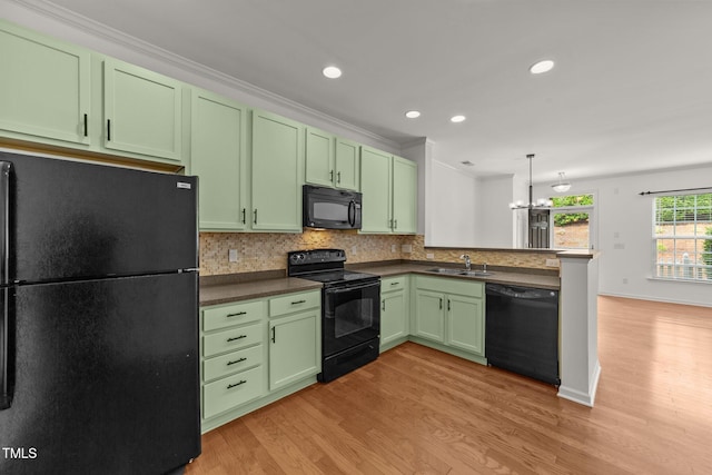 1120 Renewal Pl Unit 111, Raleigh, NC 27603 - kitchen featuring black appliances, green cabinets, a sink, light wood-type flooring, and a peninsula