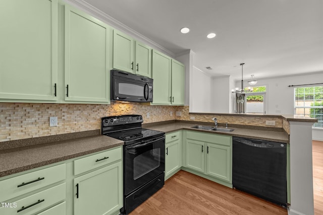 1120 Renewal Pl Unit 111, Raleigh, NC 27603 - kitchen with black appliances, green cabinets, a peninsula, light wood-style flooring, and recessed lighting