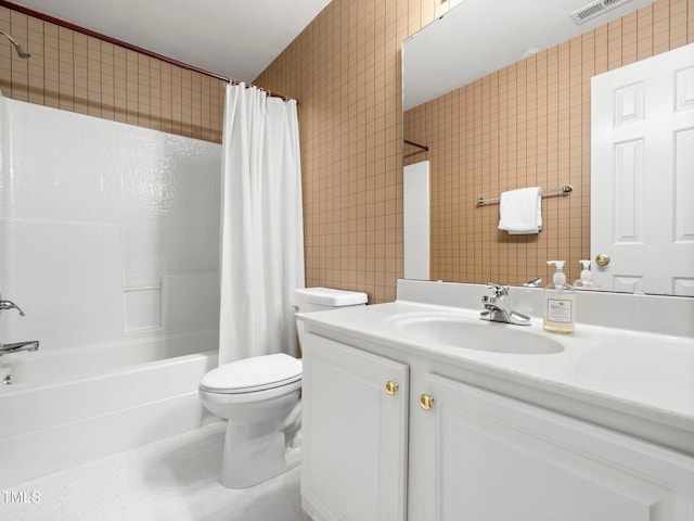 bathroom featuring toilet, shower / bath combo, vanity, wallpapered walls, and tile walls