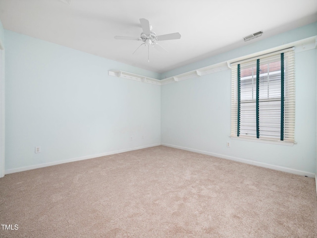 empty room featuring carpet flooring, baseboards, and ceiling fan