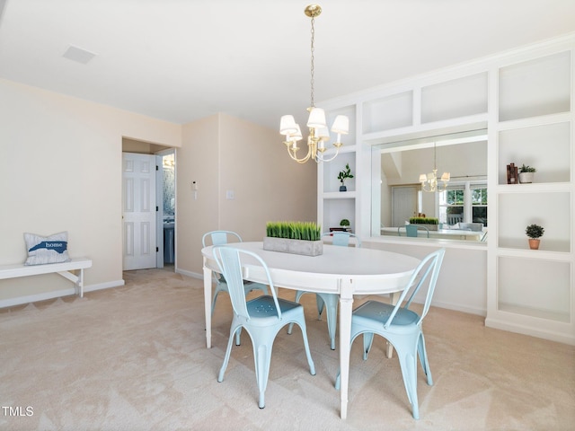 dining room featuring a chandelier, light colored carpet, and baseboards
