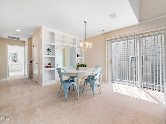 dining area with carpet flooring, a chandelier, baseboards, and built in features