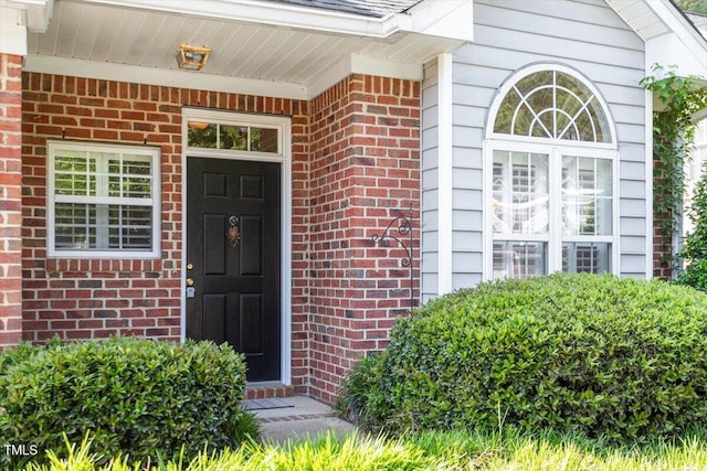 property entrance with brick siding