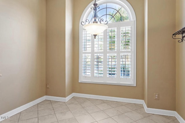 unfurnished dining area featuring light tile patterned floors and baseboards