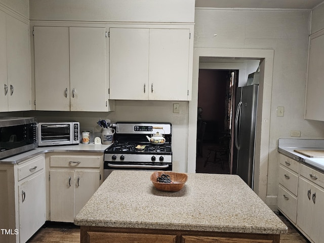 500 W Main St, Benson, NC 27504 - kitchen with appliances with stainless steel finishes, a kitchen island, and dark wood-style floors