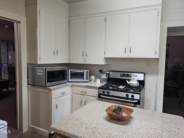500 W Main St, Benson, NC 27504 - kitchen with stainless steel appliances, light countertops, and white cabinetry