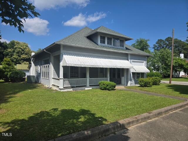 500 W Main St, Benson, NC 27504 - view of front of home featuring covered porch, a front yard, and central AC unit