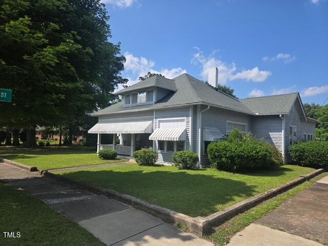 500 W Main St, Benson, NC 27504 - view of front facade featuring a front lawn and a chimney