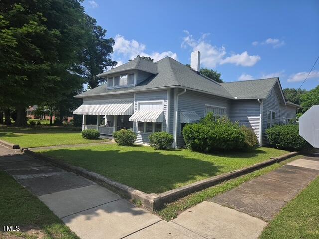 500 W Main St, Benson, NC 27504 - view of side of home with a lawn and a chimney