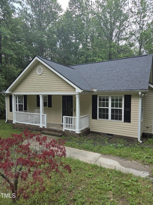 view of front facade featuring a porch and roof with shingles
