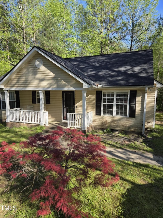 view of front of property with a porch and a shingled roof