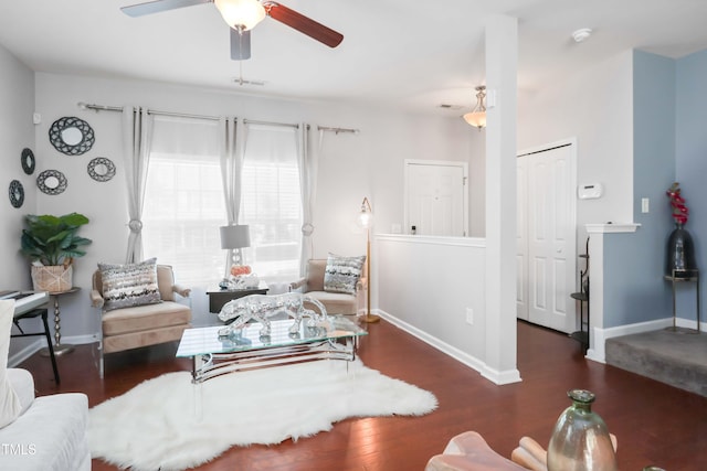 living room with baseboards, a ceiling fan, wood finished floors, and visible vents